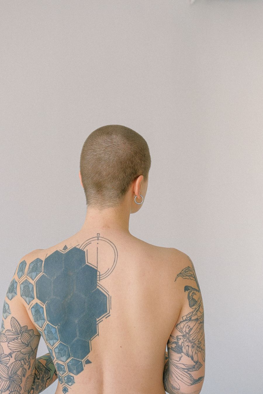 Geometric and floral back tattoos
