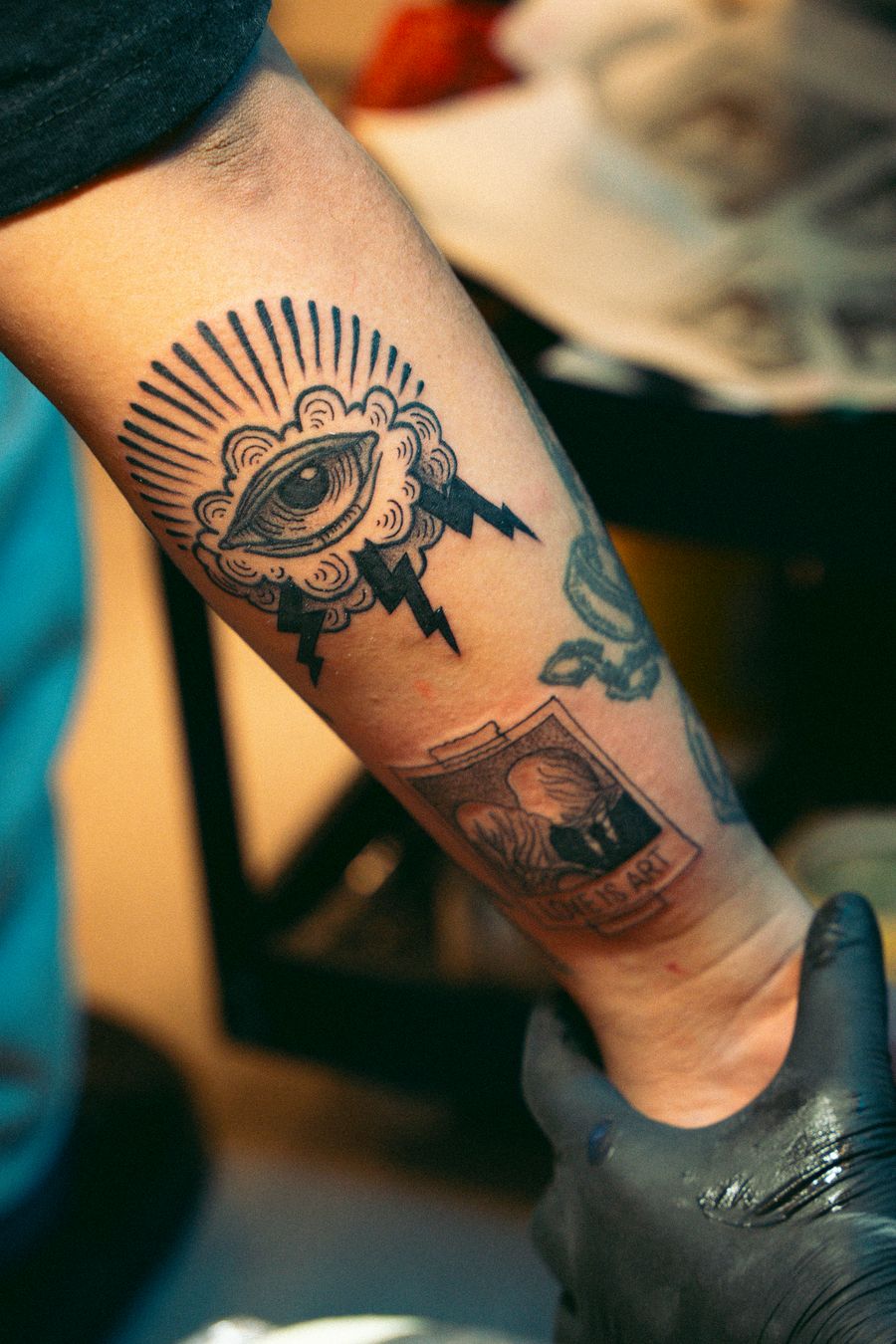 Fine line forearm tattoo in studio